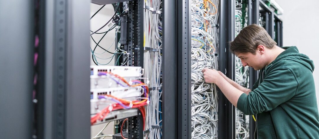 teenager-working-with-cables-in-server-room-2022-12-16-22-21-27-utc-min